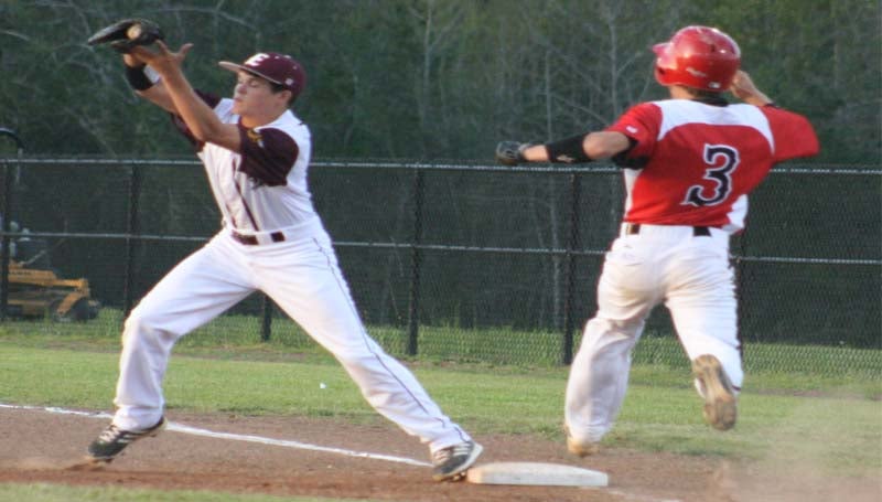 DAILY LEADER / MARTY ALBRIGHT / Enterprise's Jeffrey Daniels records the out at first base as Loyd Star runner Hayden Brownlee (3) leaps to beat the throw Tuesday night.