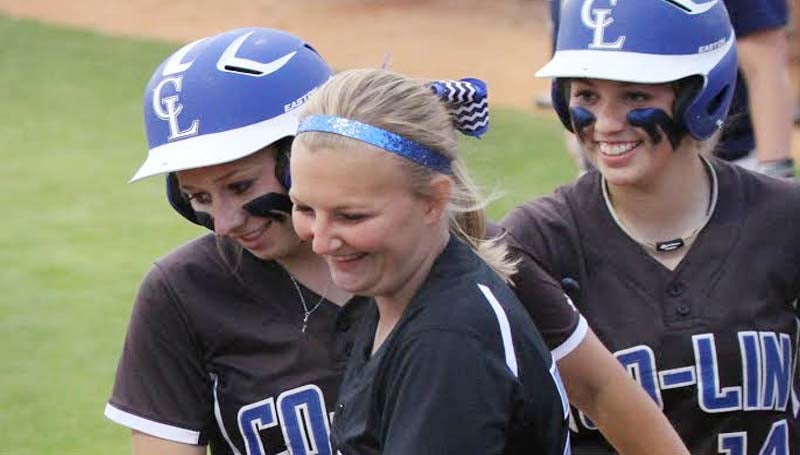 CO_LIN MEDIA / NATALIE DAVIS / Co-Lin's Beth Fortenbery (far left) is congratulated by teammates Peyton Sheffield (center) and Brooke Laigast after hitting a 3-run home run.