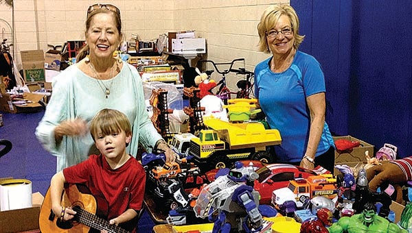 PHOTO SUBMITTED / Carolyn Hennington (left) and Joyce Bedsole, with the help of Josh Holmes, son of Sunday Holmes, sort and price items for the "I Love India" garage sale at the First Baptist Church gym. The preview sale is from 6 to 8 p.m. tonight and the sale Saturday is from 6:30 a.m. to 11 a.m. There is a $5 admission fee for the Friday night preview.