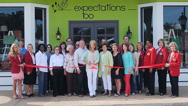 DAILY LEADER / RHONDA DUNAWAY / Mayor Joe Cox (back row, far right), Brookhaven-Lincoln County Chamber of Commerce President Dustin Walker (back row, far left), Executive Director Garrick Combs and chamber members and ambassadors were on hand for a ribbon cutting for the new retail space of Expectations Too. With business owner Angela Warren (center with scissors) is Lib Smith (right), and Warren's husband Beck Warren (left). Next to Beck Warren are his parents, Kenneth and Patsy Warren. 