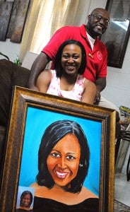 SUBMITTED PHOTO / Johnnie Turner and Allison Morris pose with the portrait Turner gave Morris for her high school graduation.