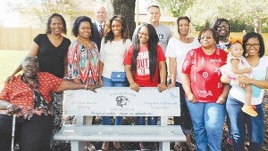 Family members gather around a bench dedicated to Jevonta Dickey and Shaquan Richardson Thursday. From left: Gertrude Hamilton, Virginia Harris, LaMesha Nobles, Fernandria Byrd, Nia Richardson, Shirley Porter-Richardson, Annie Sanders, Akyra Hunt, Cadee Mitchell and Alexis Hunt. In the back are Ben Cox and Tommy Clopton.