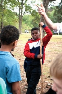 Malachi Williams learns about building fires during Outdoor Survival Club.