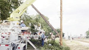 Power crews work to restore electricity following Hurricane Katrina. 