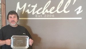 Photo submitted Ken Dixon, chef and general manager of Mitchell’s Special Events and Catering, holds the award for winning the 2015 Taste of the Trust People’s Choice Award. 