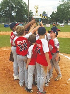 Photo Submitted/  The Lincoln American All-Stars hoist their district championship trophy after defeating Walthall 10-3 in game three of the series.  