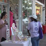 A woman stops by a table outside of Fashion Jewelry by Margaret Ann Britt on Whitworth Avenue in Downtown Brookhaven during Girls Night Out Thursday evening. (Hunter Cloud | The Daily Leader)